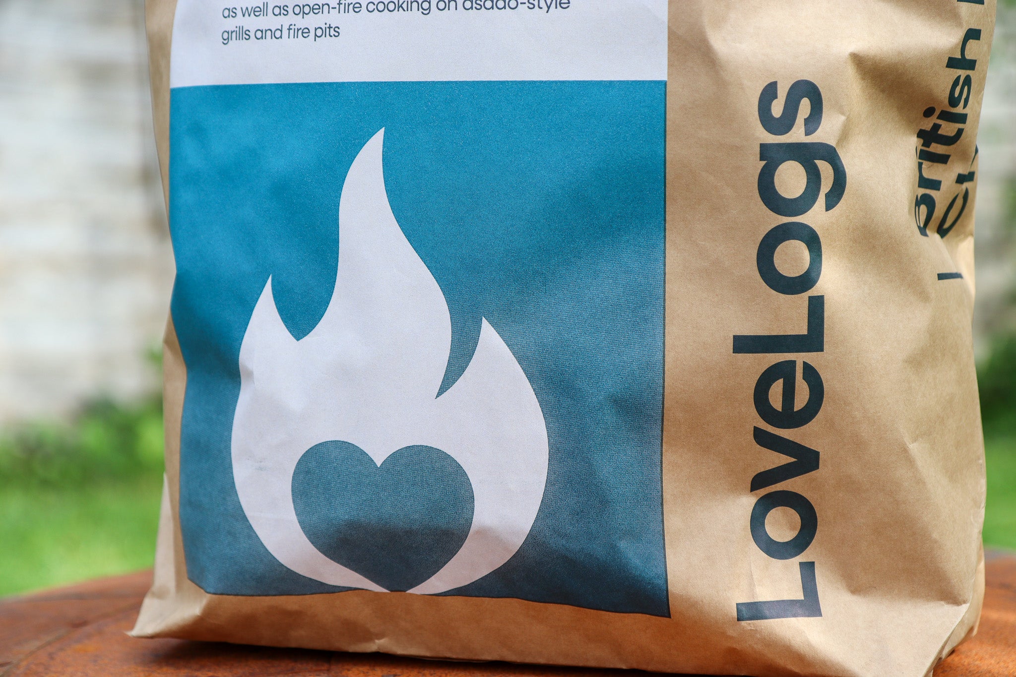 Close-up of Love Logs British cherrywood charcoal lumps and bag label