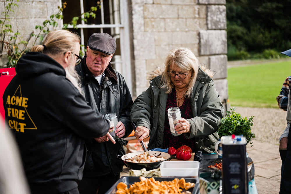 Guests cooking together at a Charlie Oven masterclass.