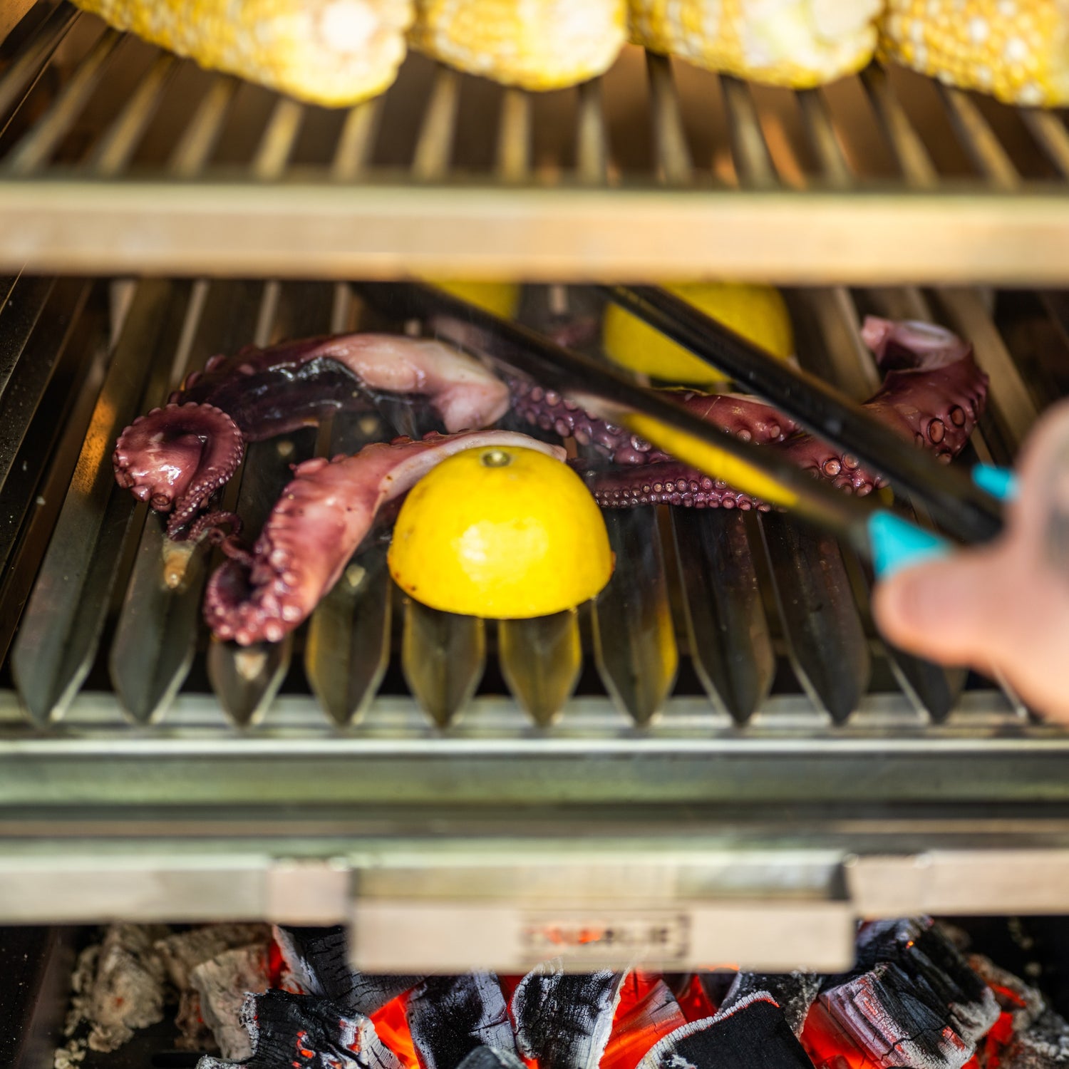 Grilling octopus and lemon on a barbecue