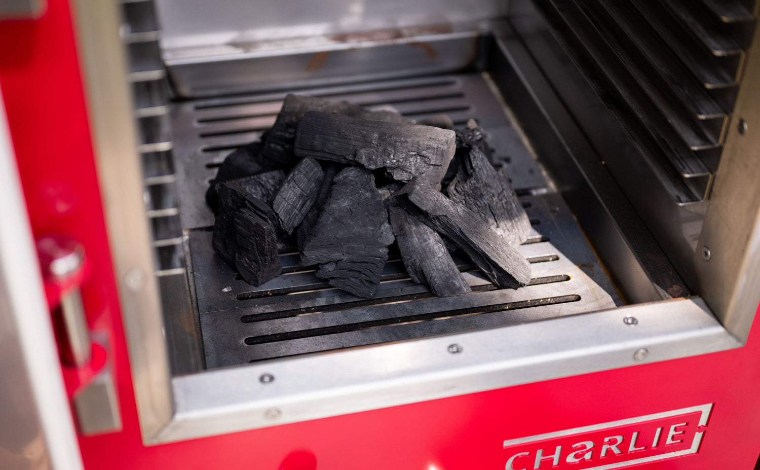 Charcoal in a grill grate of a barbecue machine.