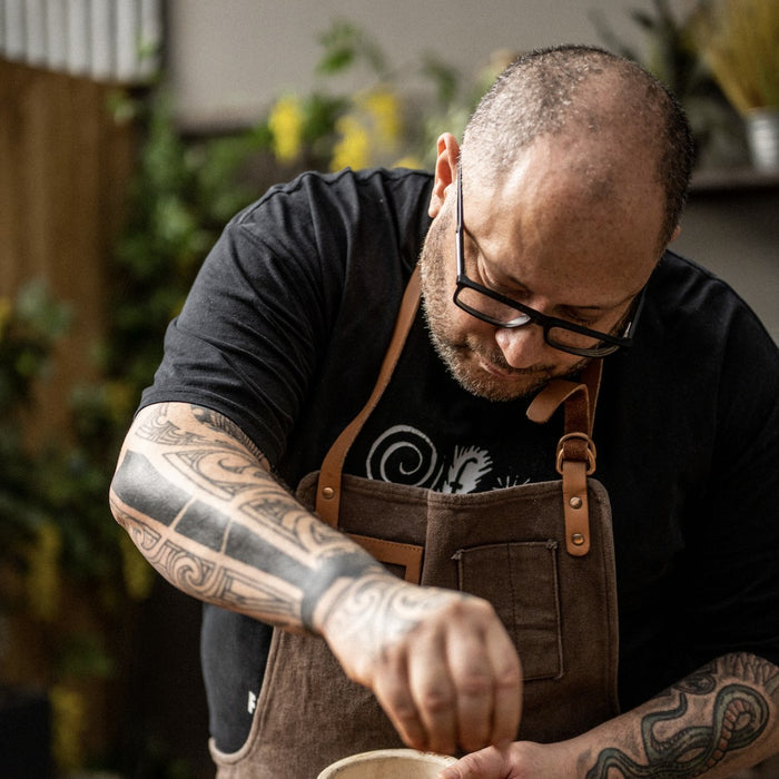 Chef Mat Blak seasoning a smoked joint of meat