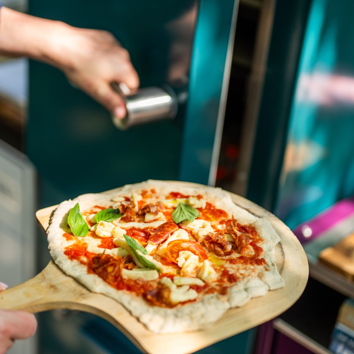 pizza ready to cook going into the charlie oven