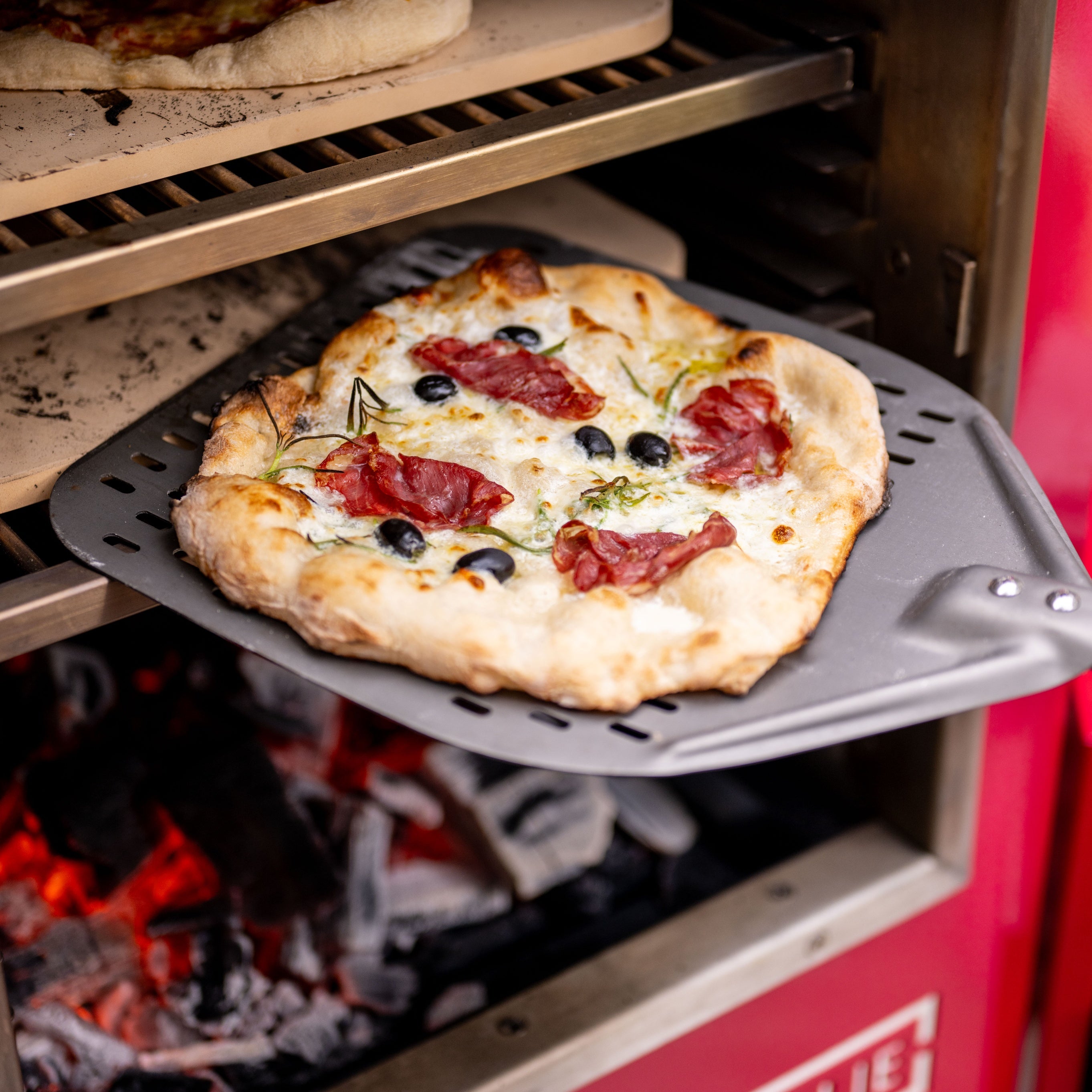 Pizzas coming out of the charlie oven cooking on several levels at once