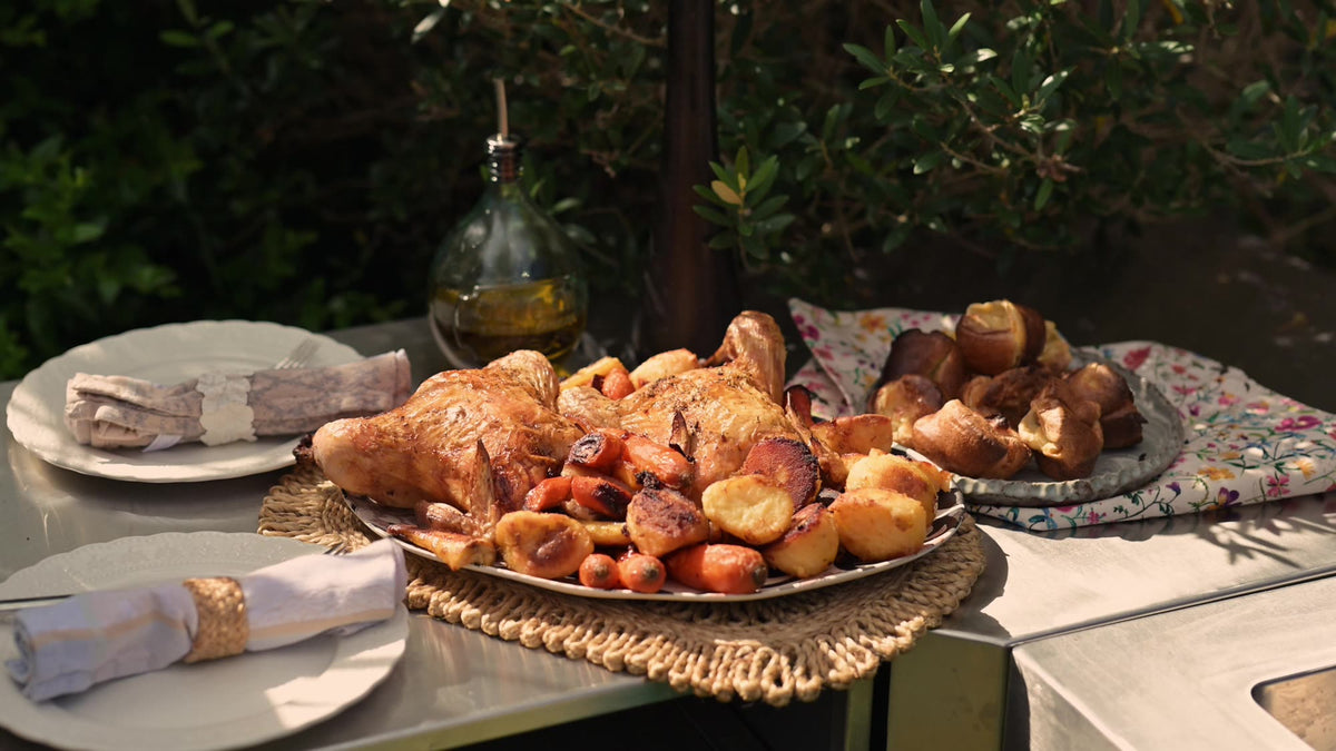Roast chicken lunch laid on a garden table