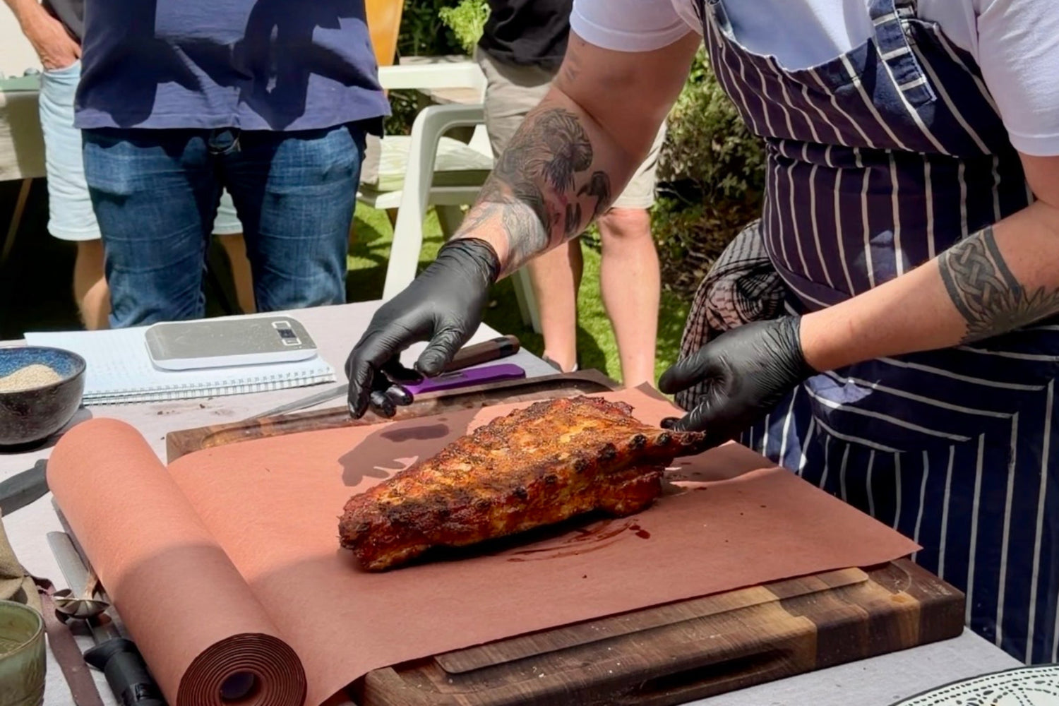 Whole smoked pork belly cooking in a Charlie Oven with applewood smoke