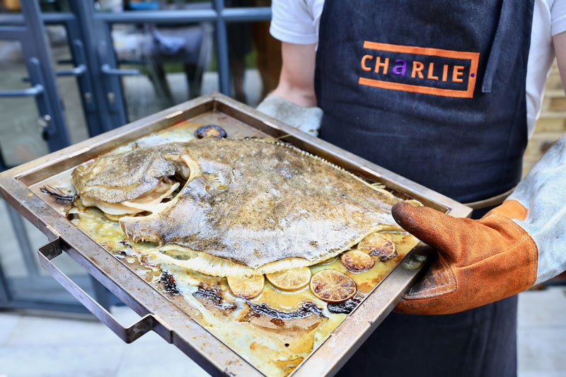 Whole Wood Fired Turbot with Lime, Thyme, And Hazelnut Vinaigrette by Chef Bart Van Der Lee.