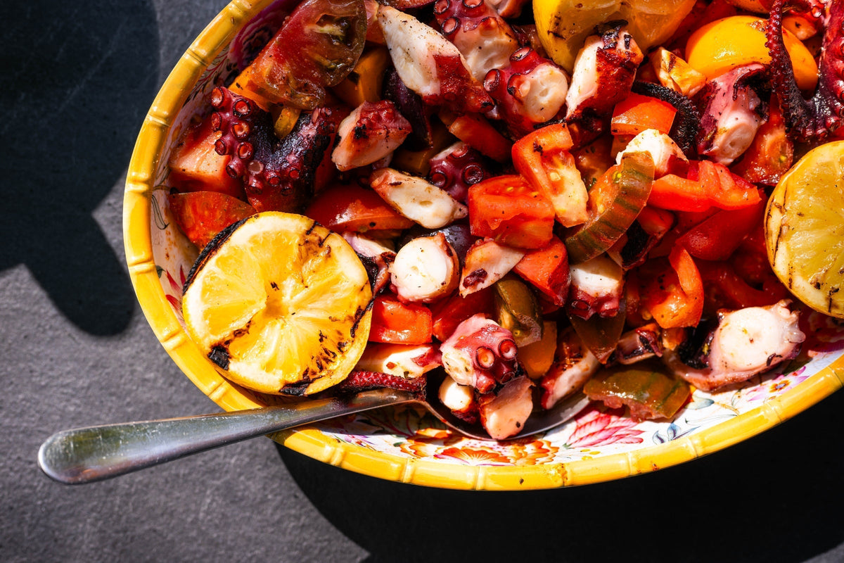 Charred octopus with grilled lemon and heritage tomato salad