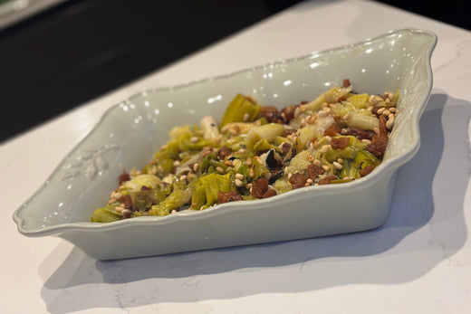 Ember Baked Leeks with Mangalitsa Pork Fat, Burnt Lemon and Toasted Pine Nuts