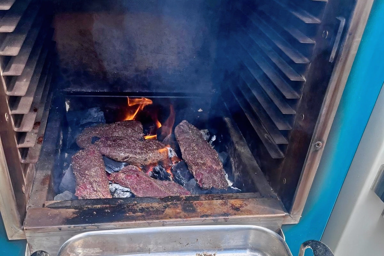 denver steaks cooked over charcoal