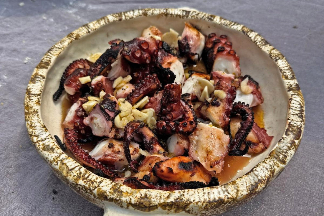 Greek grilled octopus charred over charcoal with lemon and oregano