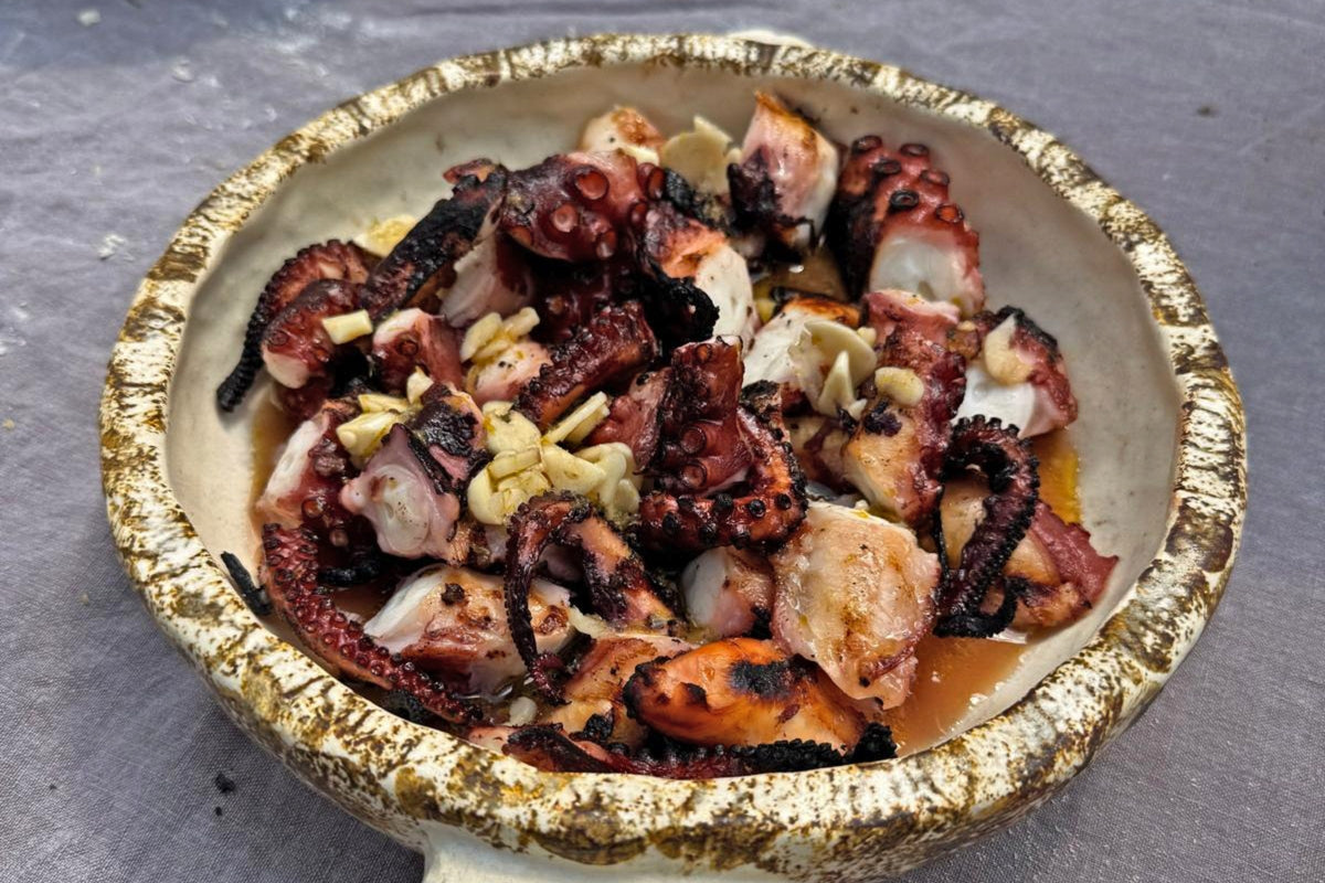 Greek grilled octopus charred over charcoal with lemon and oregano