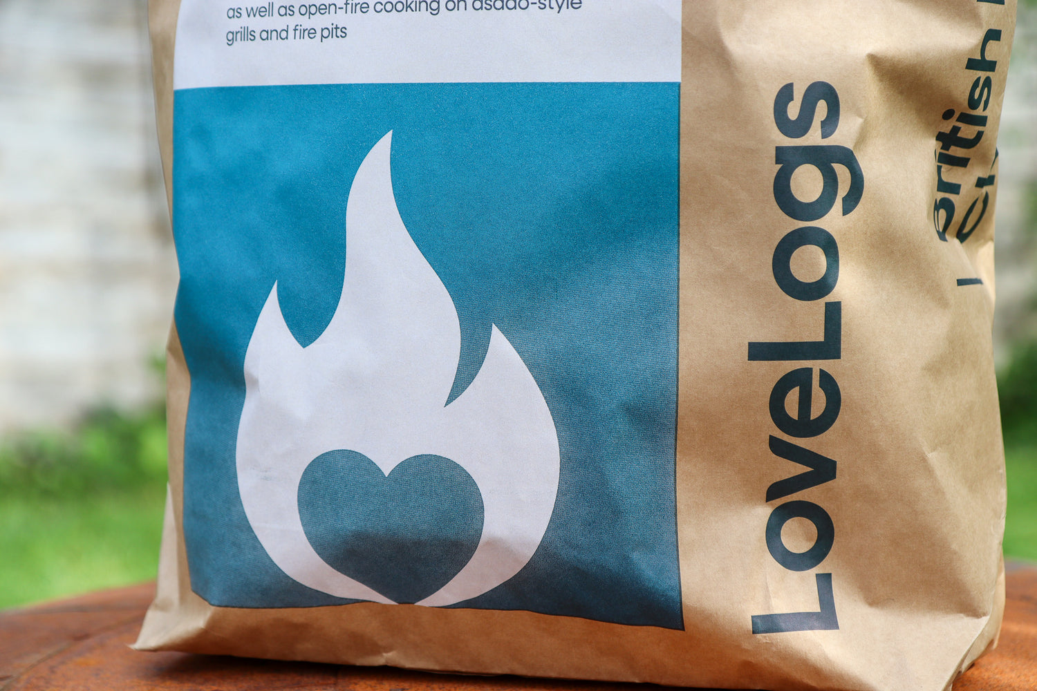 Close-up of Love Logs British cherrywood charcoal lumps and bag label
