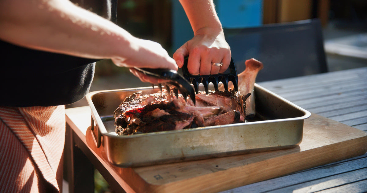 A slow-cooked pork shoulder resting after several hours in a Charlie Charcoal Oven