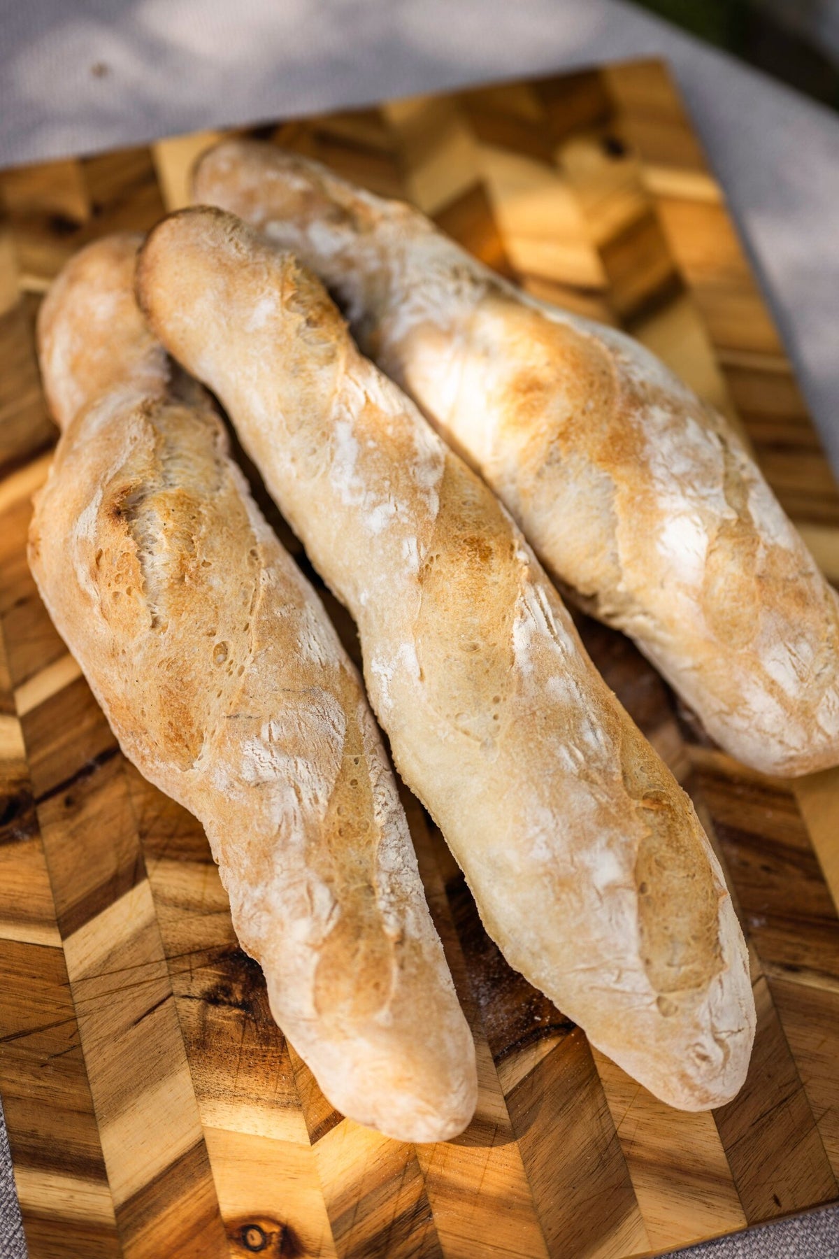 Three baguettes on a chevron wooden board