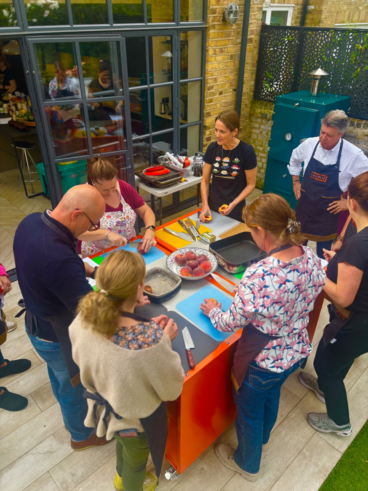 Guests preparing food together at a Charlie Oven cooking masterclass