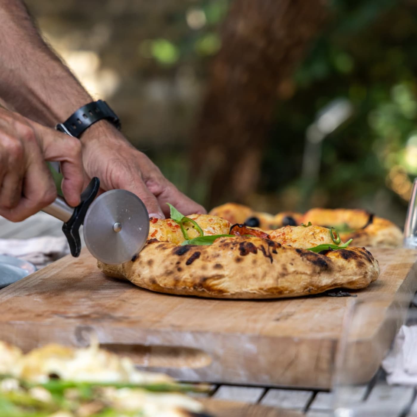 Pizza's baked in the Charlie Oven.  It's a pizza oven, BBQ and Smoker all in one.  