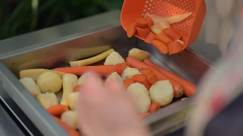 Potatoes and carrots going into the Deep Roasting Tray Rack