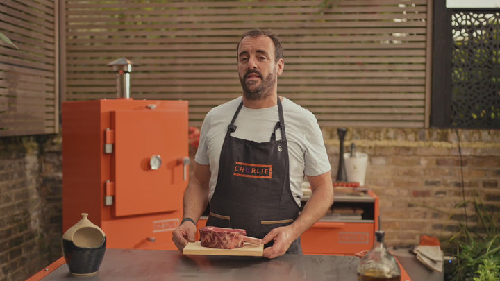 James Wheltor cooks a thick bone-in ribeye on Charlie’s Argentine grill