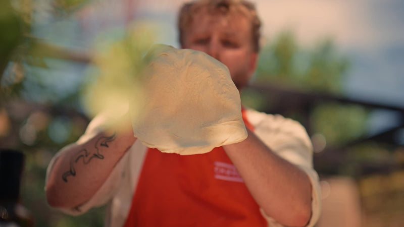 Stretching pizza dough by hand